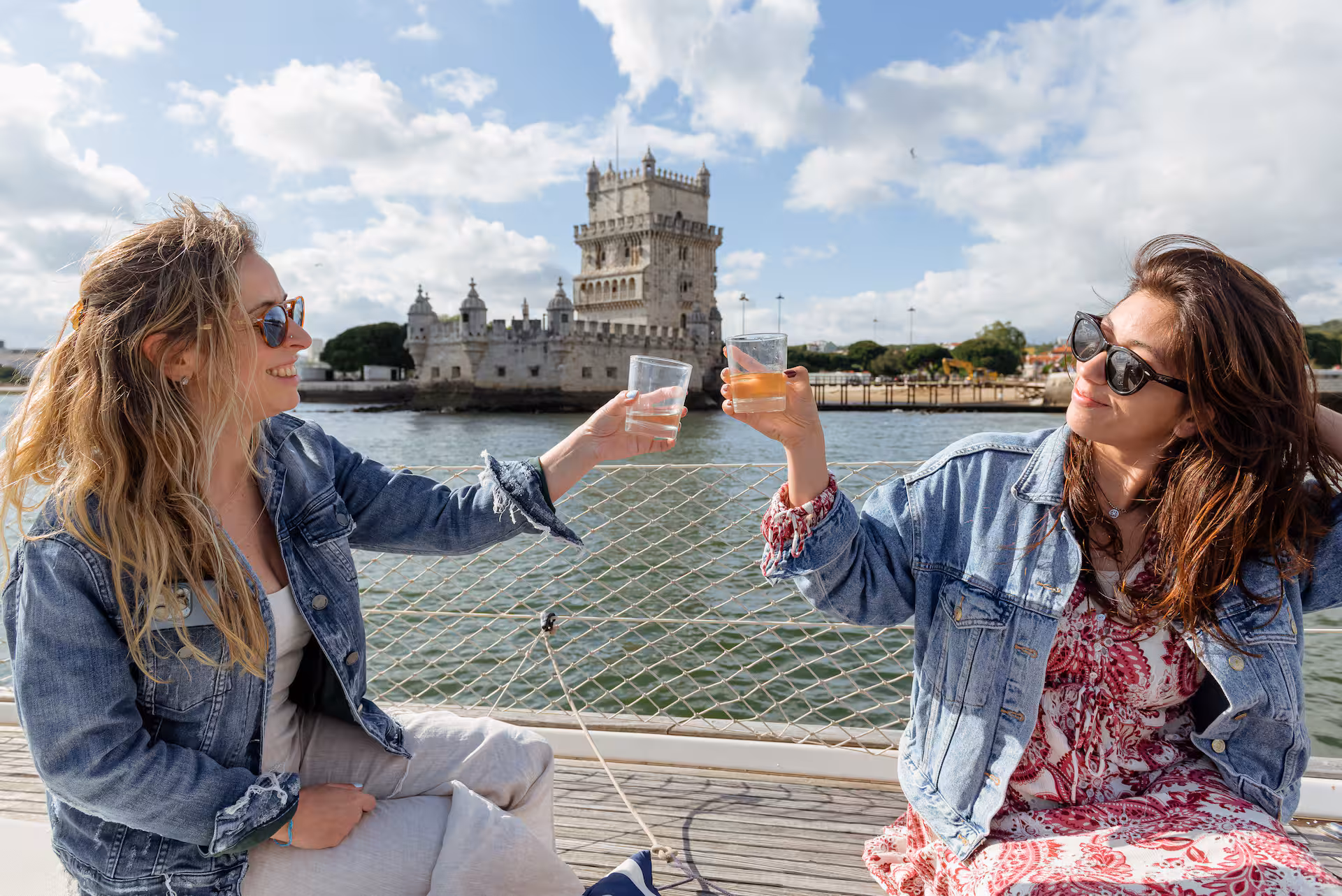 View of Cristo Rei and Ponte 25 de Abril from a private sailboat on the Tagus River in Lisbon