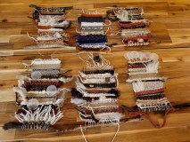 Colorful wool and fiber materials arranged on a weaving table