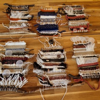 Colorful wool and fiber materials arranged on a weaving table