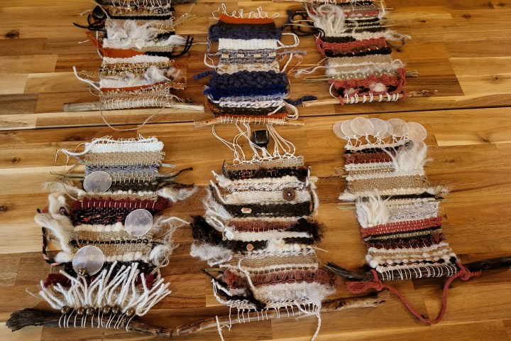 Colorful wool and fiber materials arranged on a weaving table