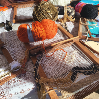 Traditional loom with wool threads against a stone wall, Algarve