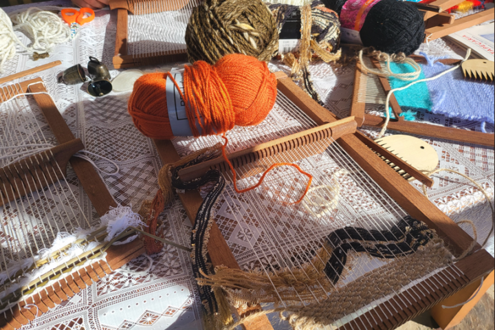 Traditional loom with wool threads against a stone wall, Algarve